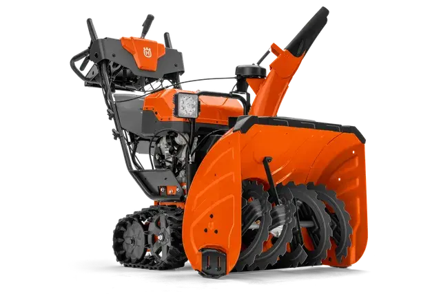 Zijaanzicht van een Husqvarna-sneeuwblazer met zichtbare vijzel en bedieningselementen.